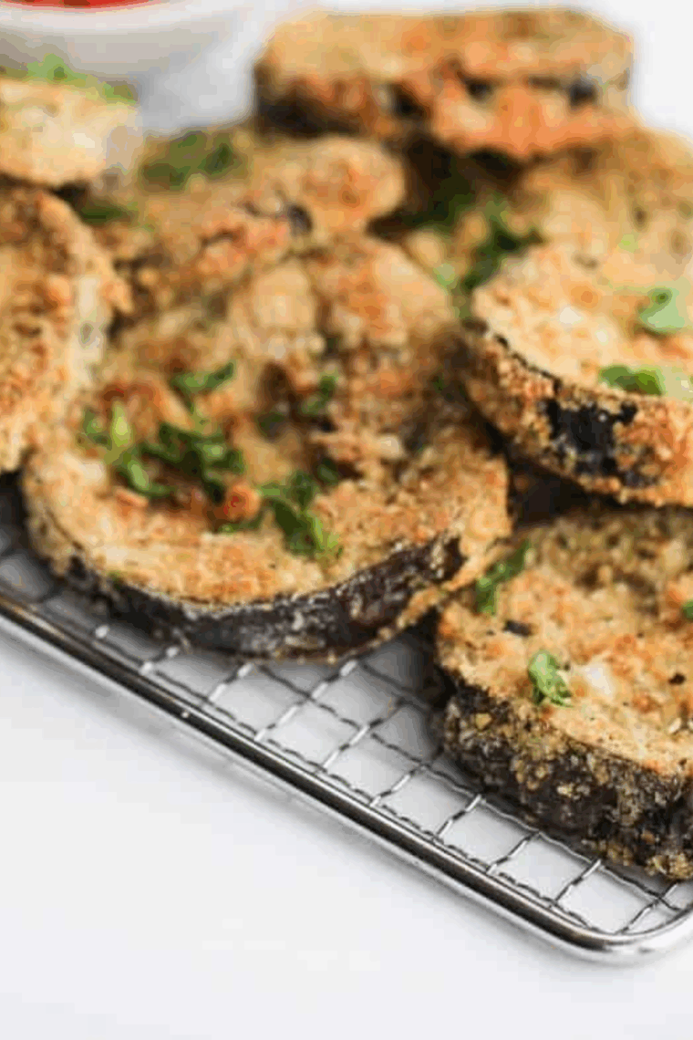 Extra-crispy gluten-free eggplant parmesan cooked in the air fryer with golden breaded slices, marinara sauce, and melted mozzarella cheese
