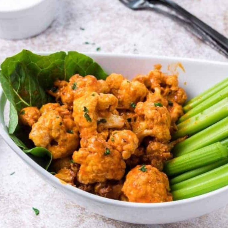 Crispy frozen buffalo cauliflower cooked in the air fryer, ready to serve.