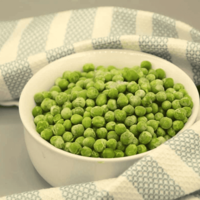 Ingredients needed for Frozen Peas In Air Fryer on kitchen table.