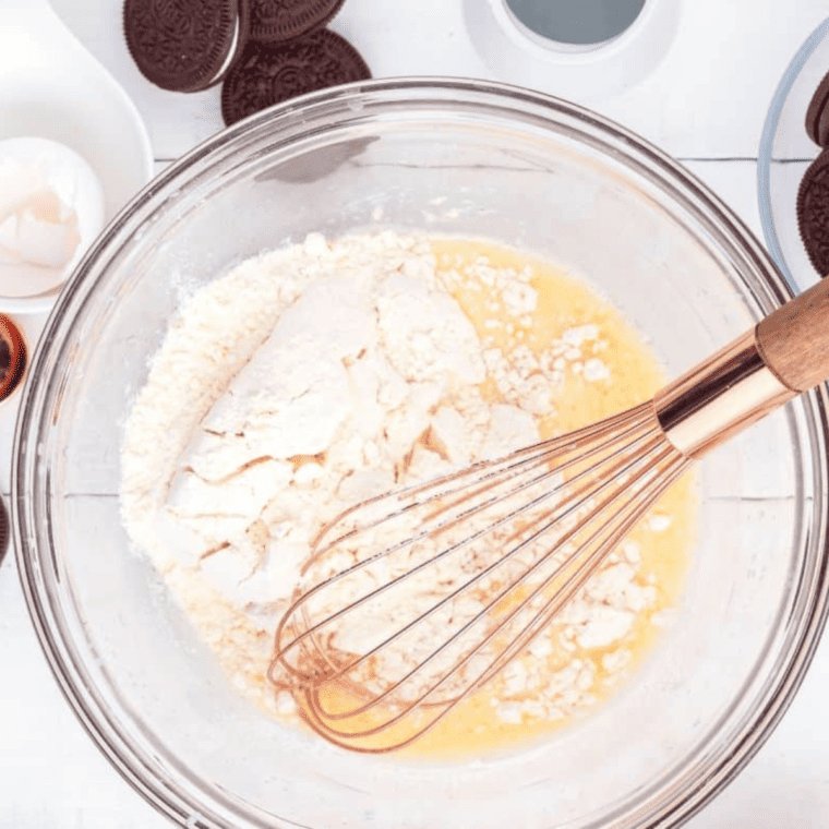 Stirring pancake mix into wet ingredients with a silicone spatula until smooth.
