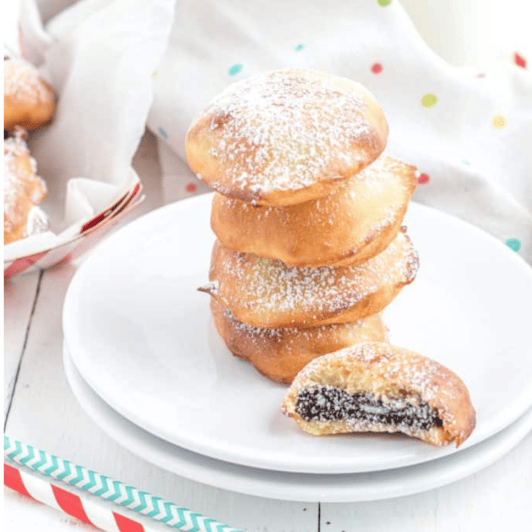 Air fried Oreos coated in pancake batter, golden and crispy, served on a plate.