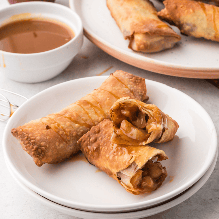 Copycat Panda Express Apple Pie Egg Rolls with cinnamon-sugar coating, cut to show diced apple filling.