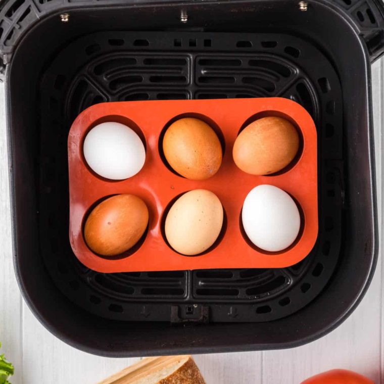 Hard-boiled eggs cooking in the air fryer basket