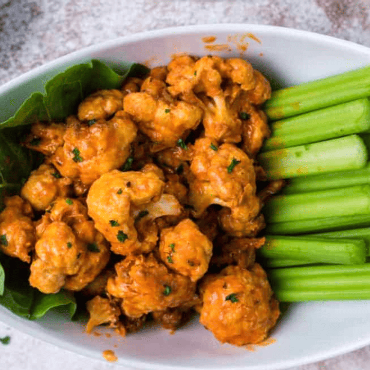 To master the art of making perfect Air Fryer Buffalo Cauliflower Bites, consider these pro tips for a fantastic cooking experience: Cut Evenly: When preparing the cauliflower florets, aim for uniform sizes. This ensures that even cooking and all your bites will be ready simultaneously. Preheat Your Air Fryer: Just like an oven, it's essential to preheat your air fryer. This helps achieve that crispy exterior more effectively. Use Parchment Paper or a Liner: To prevent the cauliflower from sticking to the air fryer basket, use parchment paper or a silicone liner. This makes cleanup a breeze. Don't Overcrowd the Basket: Arrange the cauliflower bites in a single layer with some space between them. Overcrowding can lead to uneven cooking and less crispy results. Shake or Flip: Halfway through the cooking time, shake the basket or flip the cauliflower bites. This promotes even cooking and crispiness on all sides. Monitor Cooking Time: Keep an eye on the cauliflower as it cooks, as cooking times may vary depending on your specific air fryer model. Adjust as needed to avoid overcooking. Serve Immediately: Buffalo cauliflower bites are best enjoyed fresh out of the air fryer when they are crispy. Serve them immediately for the ultimate flavor and texture. Double Coating for Extra Crispiness: For an even crunchier texture, double-coat the cauliflower bites in the flour and egg mixture before air frying. Adjust Sauce to Taste: Buffalo sauce can vary in spiciness, so taste it before tossing the cauliflower. If you prefer a milder flavor, dilute the sauce with melted butter or honey. Serve with Dipping Sauce: Prepare a dipping sauce, such as ranch or blue cheese dressing, to complement the spicy buffalo flavor. It provides a cool contrast and enhances the overall experience. With these pro tips in mind, you'll be well on your way to creating irresistibly delicious Air Fryer Buffalo Cauliflower Bites that are crispy, flavorful, and satisfying. Enjoy your homemade appetizer or snack!