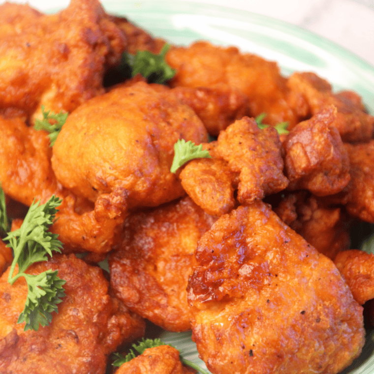 Close-up of saucy buffalo chicken bites served with celery sticks