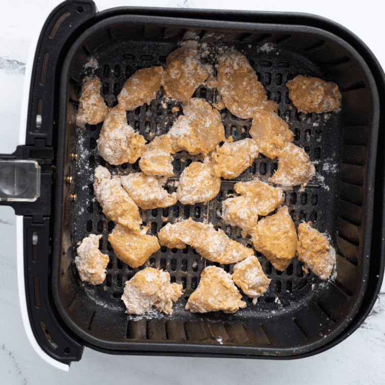 Golden air-fried chicken bites in the basket after cooking