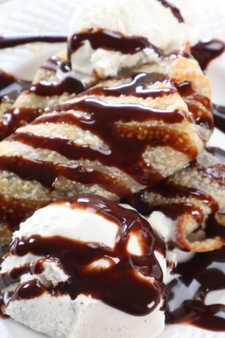 Crispy cookie dough egg rolls served warm with vanilla ice cream and hot fudge sauce