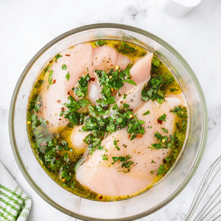 Step-by-step process: pouring Italian dressing over chicken breasts