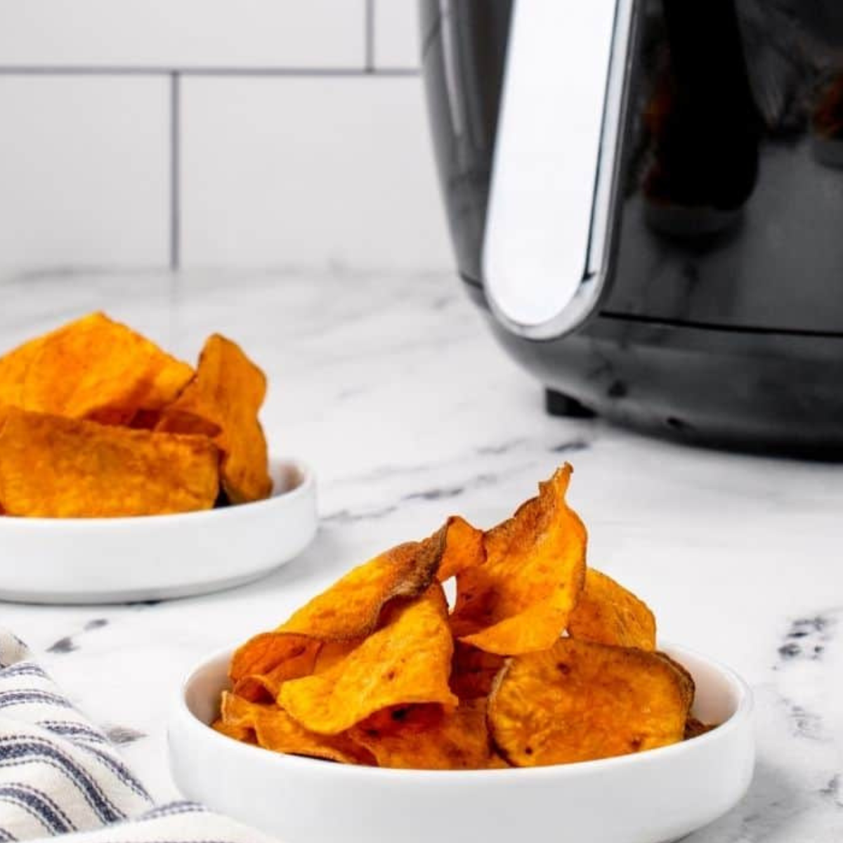 Crispy air fryer sweet potato chips on a plate..