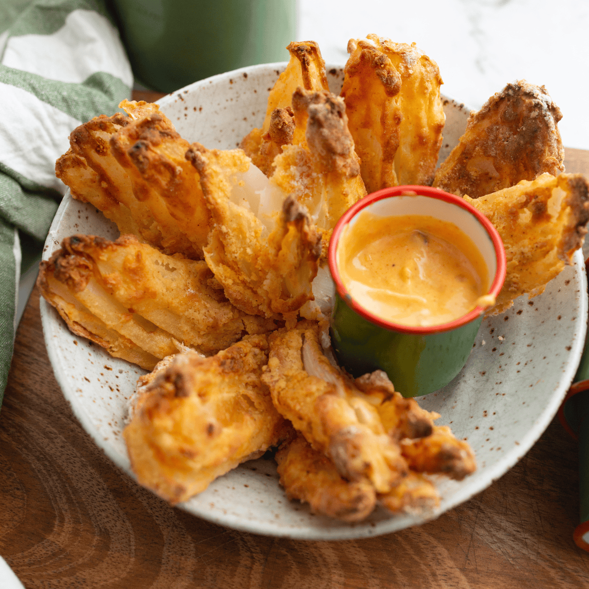 Homemade Copycat Texas Roadhouse Cactus Blossom, crispy fried onion petals served with zesty dipping sauce.