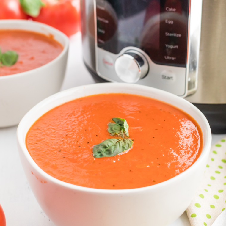 "Instant Pot displaying the finished tomato soup with a ladle ready to serve."