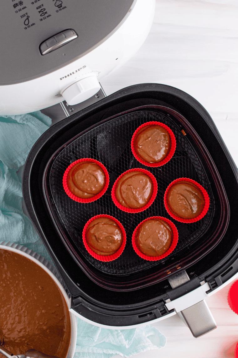 Cupcake batter poured into lined muffin tin, ready for air frying.