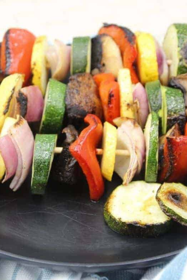 Colorful vegetable skewers sizzling on a Blackstone griddle