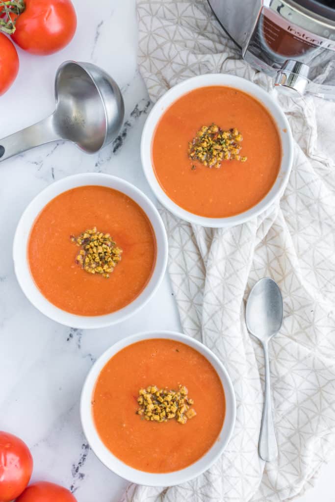"Pouring the blended tomato soup back into the Instant Pot to heat through and adjust seasoning."