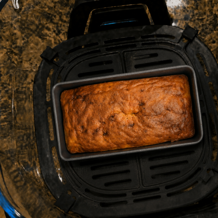 Banana bread baking in the glass container of a Ninja Crispi air fryer