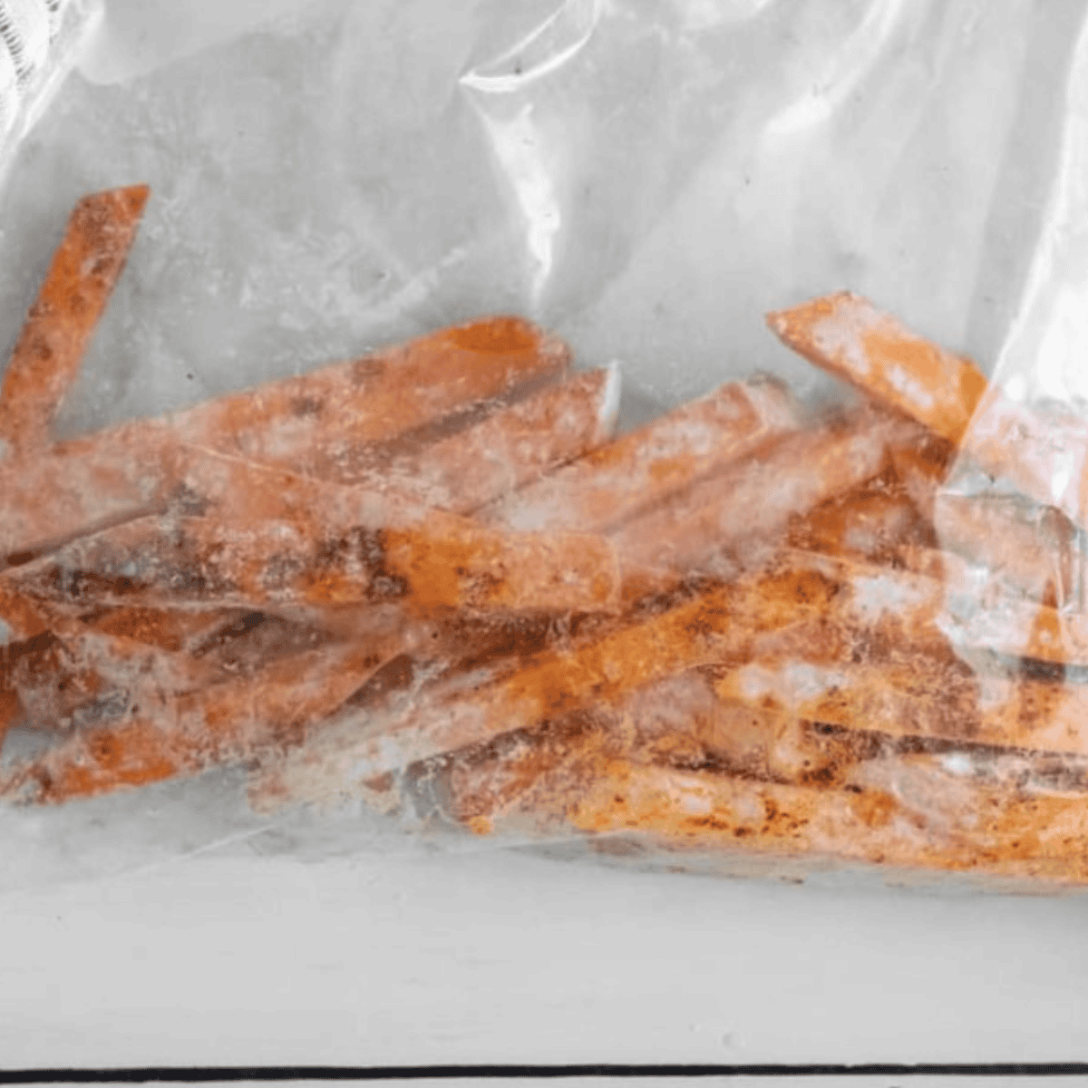 Sweet potato fries tossed in olive oil, salt, garlic powder, and cinnamon for even coating.