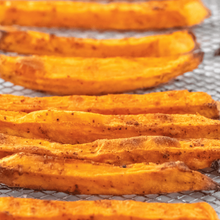 Golden, crispy Outback Steakhouse Sweet Potato Fries served with a dipping sauce, seasoned to perfection.