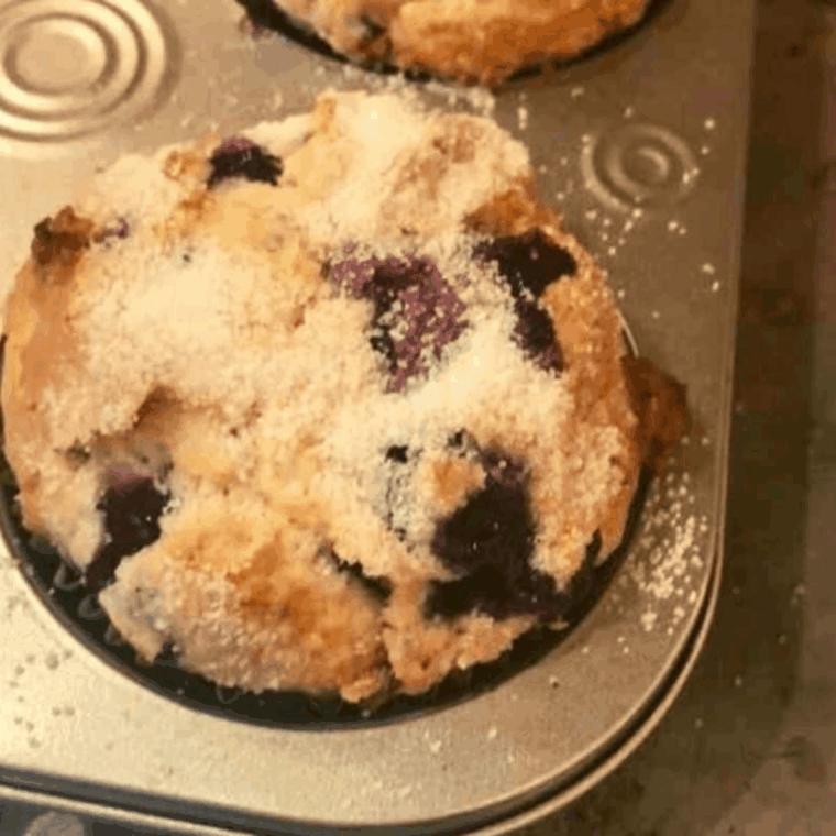 Golden air fryer berry cream muffins with juicy berries and creamy centers, freshly baked and ready to enjoy.