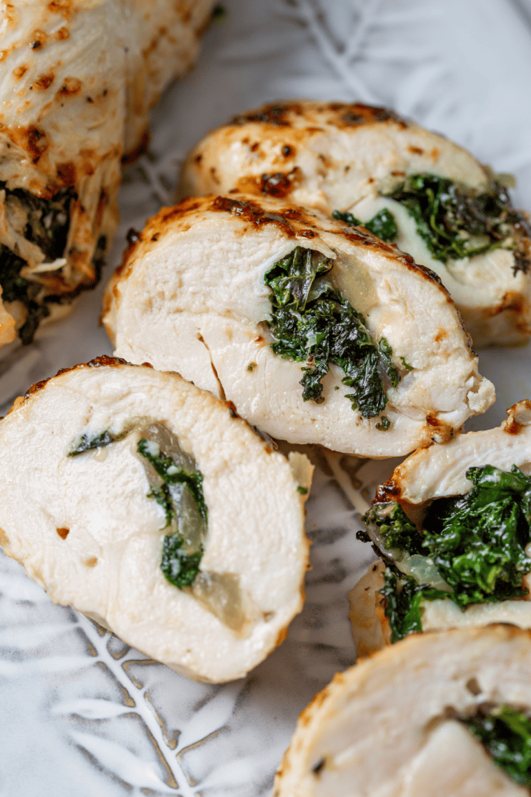 Golden crispy air fryer Chicken Kiev cut open with melted garlic herb butter flowing from the center of juicy chicken breast.
