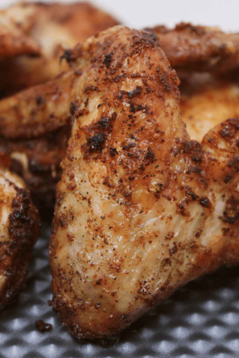 Close-up of a plate of crispy Air Fryer Dry Rubbed Chicken Wings, showcasing the seasoned coating and golden-brown texture