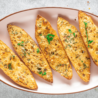 Air fryer garlic bread with fresh herbs, real butter, and parmesan. Crispy outside, soft inside, ready in under 10 minutes — no preheating needed.
