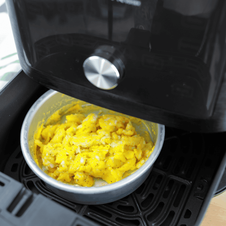 Soft scrambled eggs being cooked in a skillet until just set.
