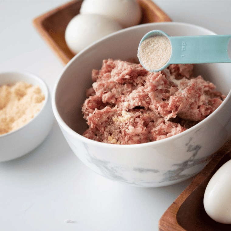 Raw eggs placed in air fryer basket cooking at 300°F before ice bath and peeling