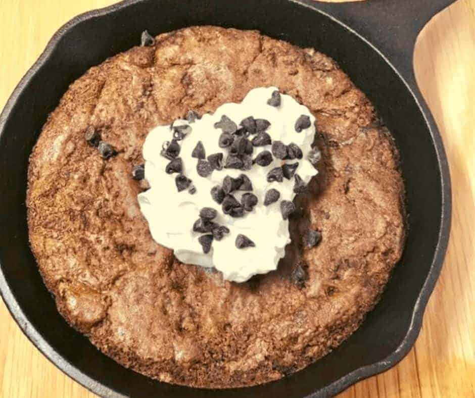 Removing the skillet from the air fryer with freshly baked brownies
