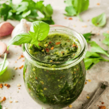 A bowl of homemade Bonefish Grill chimichurri sauce, featuring fresh herbs, garlic, and a vibrant green color, ready to serve.