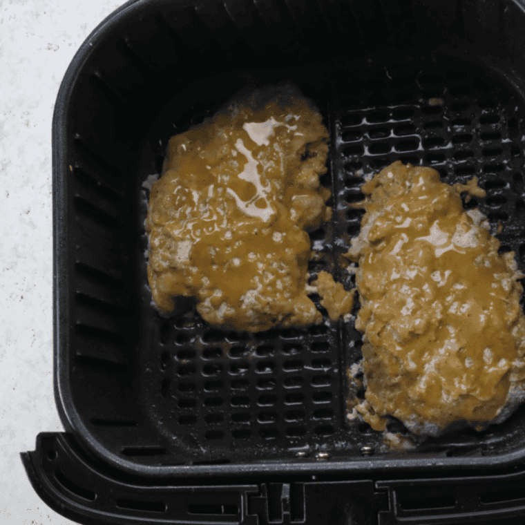 Place the coated chicken fried steak in the air fryer basket.