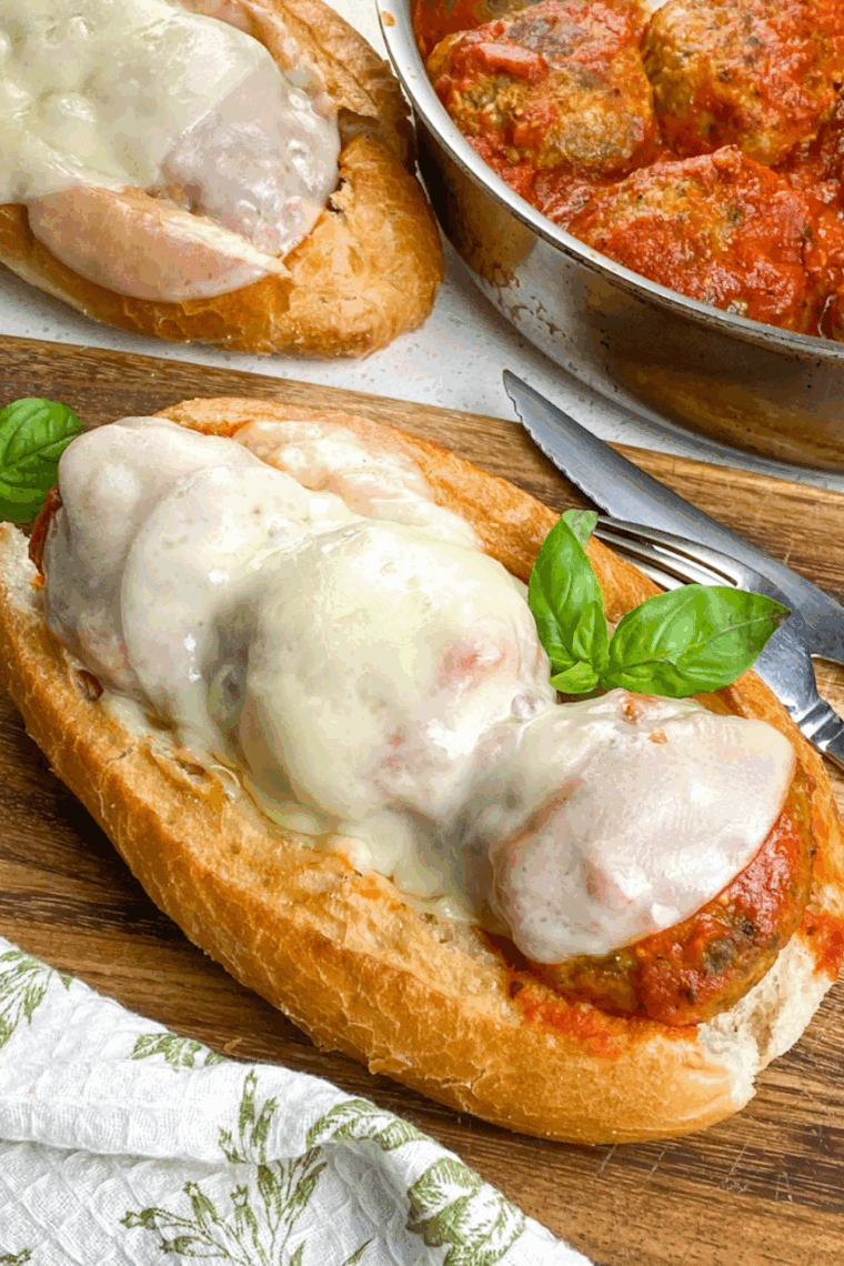 Instant Pot meatball sub sandwich with marinara sauce and melted cheese on a soft hoagie roll.