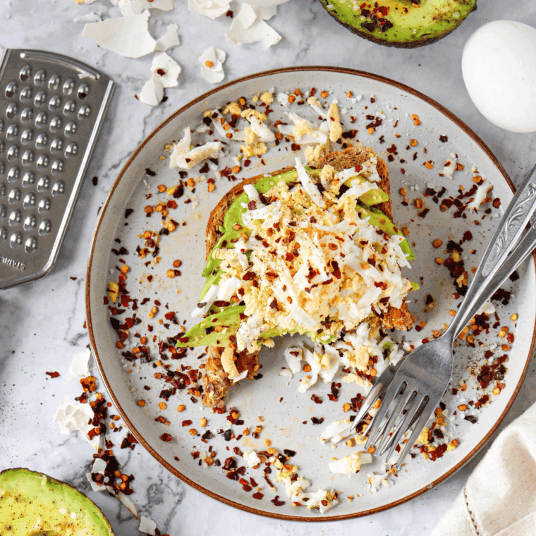  Air Fryer Grated Egg & Avocado Toast with creamy avocado, grated egg, and a sprinkle of seasoning on crispy toast.