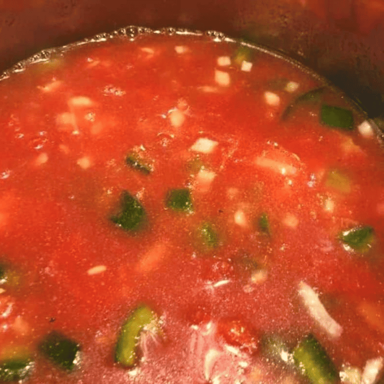 Adding broth, spices, and rice to Instant Pot and stirring until evenly combined and fully submerged