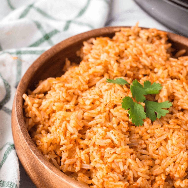 Garnishing Instant Pot Spanish rice with cilantro and lime for fresh finishing flavor