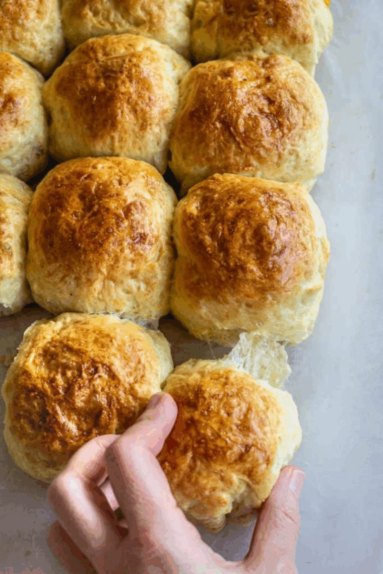 Golden, fluffy sourdough discard dinner rolls freshly baked and ready to serve
