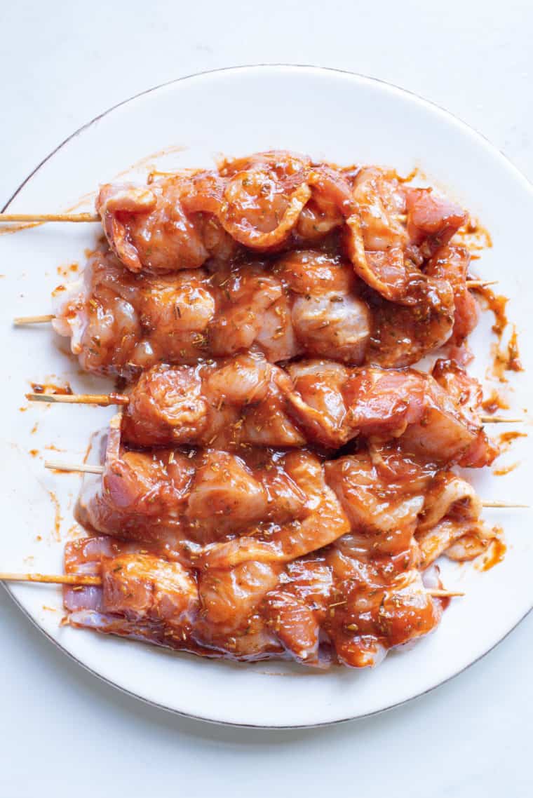 Brush each bacon-wrapped chicken bite with barbecue sauce, adding honey or brown sugar for extra sweetness.