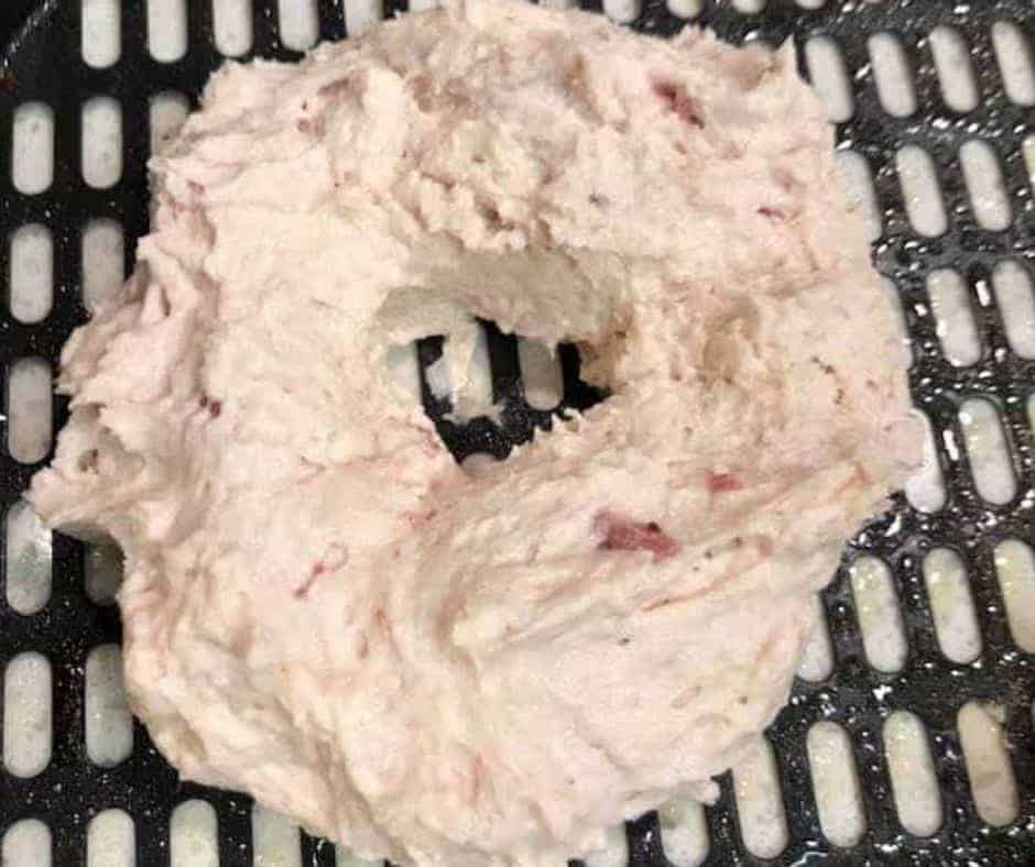 Shaping Bagels: Forming dough into bagel shapes on a floured surface.