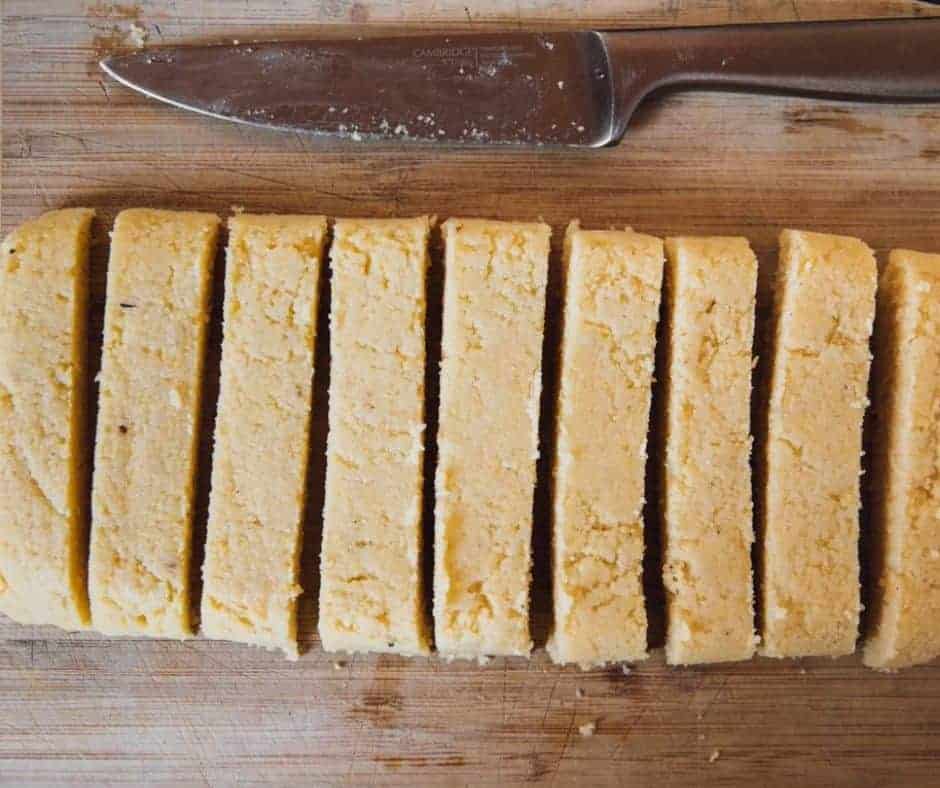 Cooked polenta spread in a parchment-lined pan to set