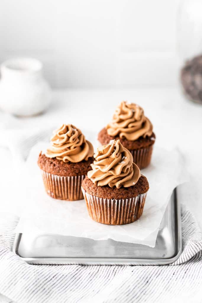 Decorating cupcakes with frosting and a dash of salt.