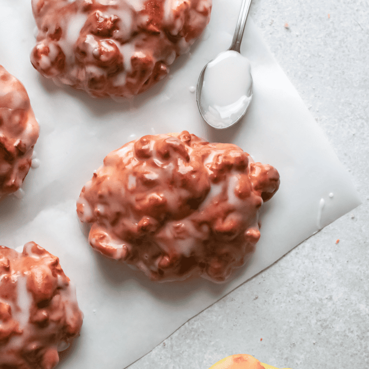 Finished air fryer apple fritters served warm on a plate