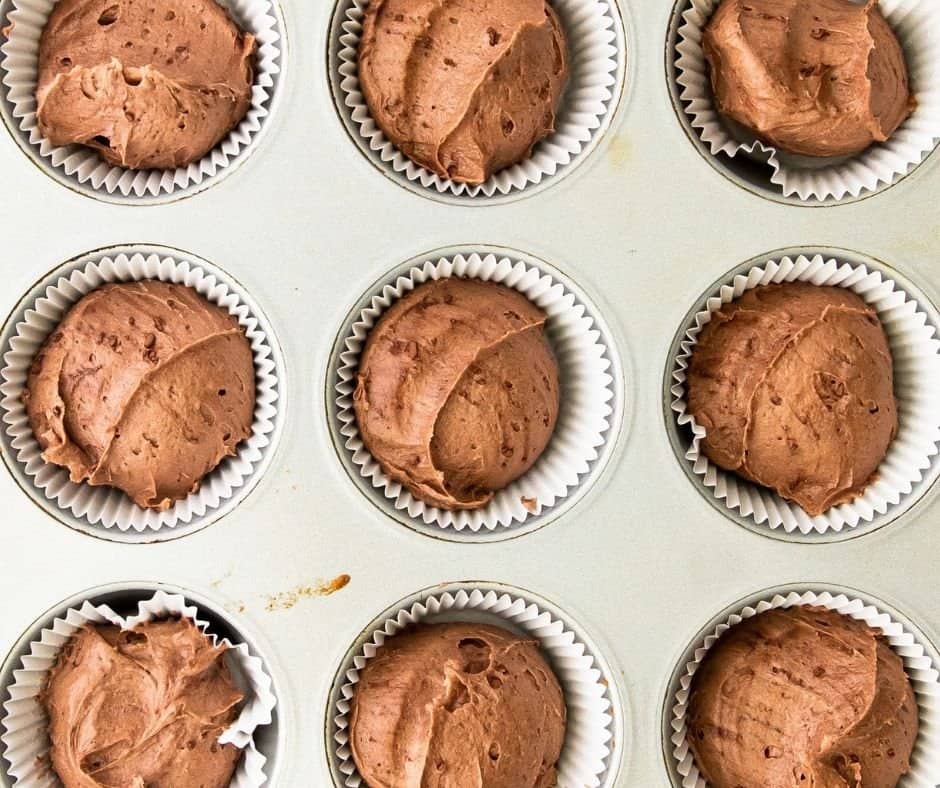 Fill the cake liners with the chocolate cake mix.