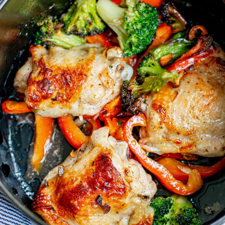 Cooked honey balsamic chicken thighs resting on a plate, ready to be served with glaze drizzled on top.