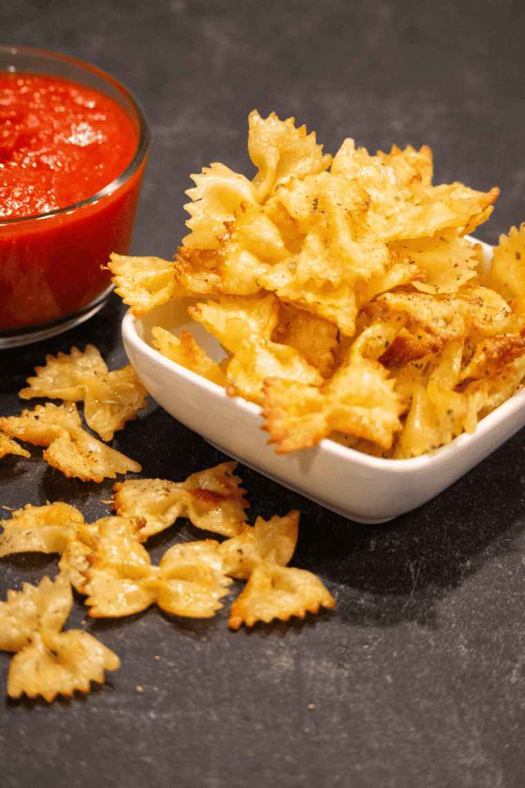 Golden brown pasta chips cooked in the air fryer with parmesan seasoning