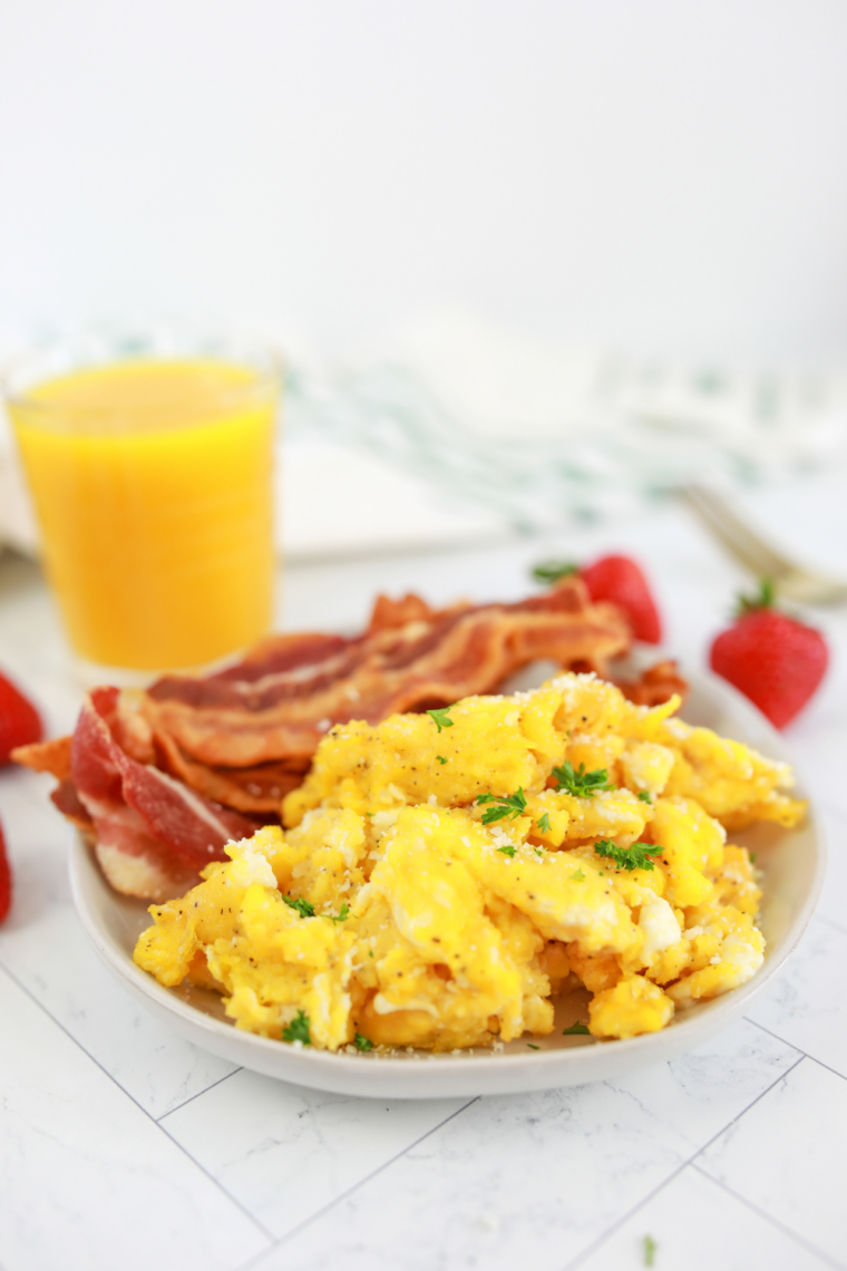 creamy scrambled eggs in air fryer basket with fork texture