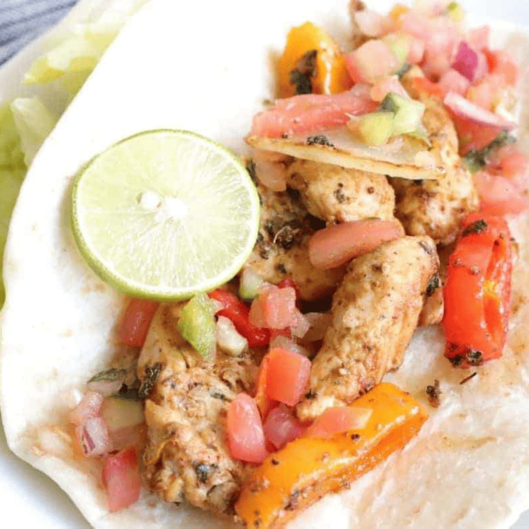Close-up of juicy air fryer chicken fajitas with charred pepper edges