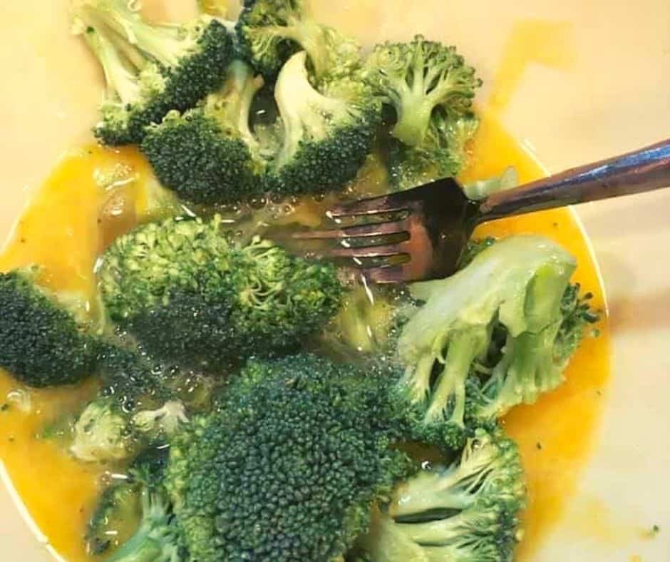 Broccoli in Bowl mixed with the other ingredients, to make the filling of the quiche.