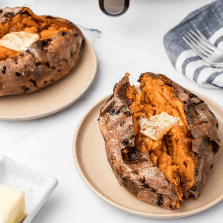 Air fryer Longhorn sweet potato split open with melted cinnamon butter on top