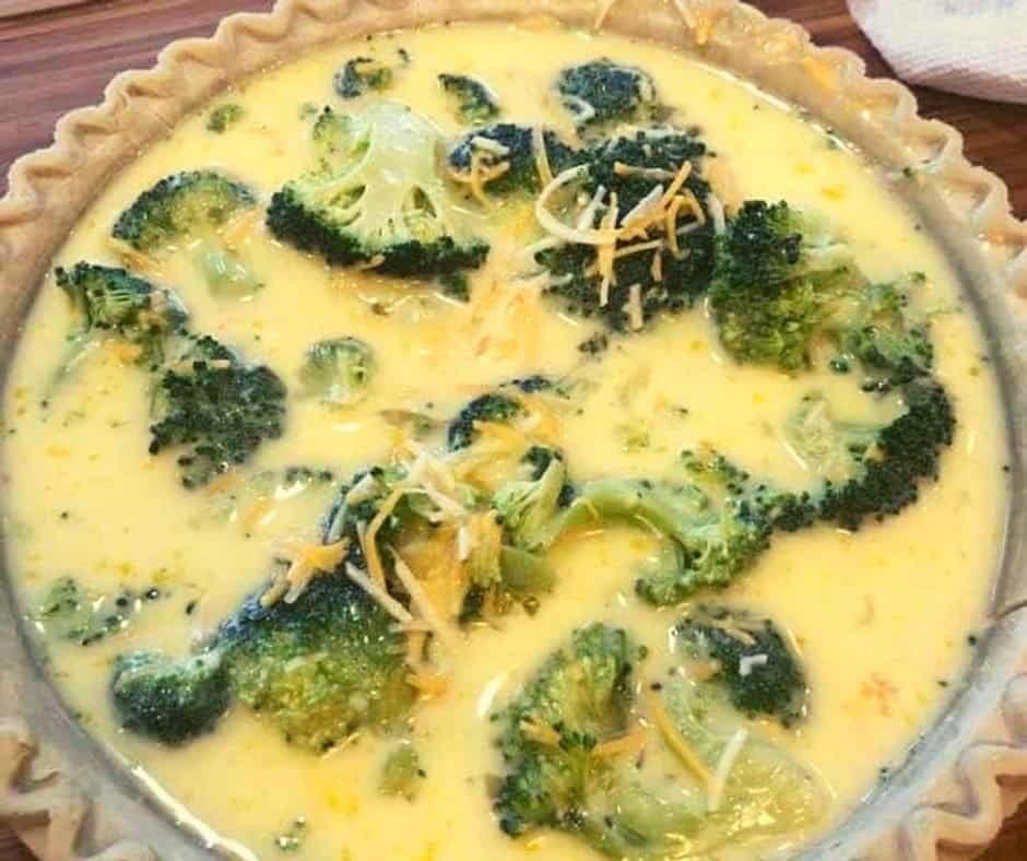 Adding the filling to the quiche.