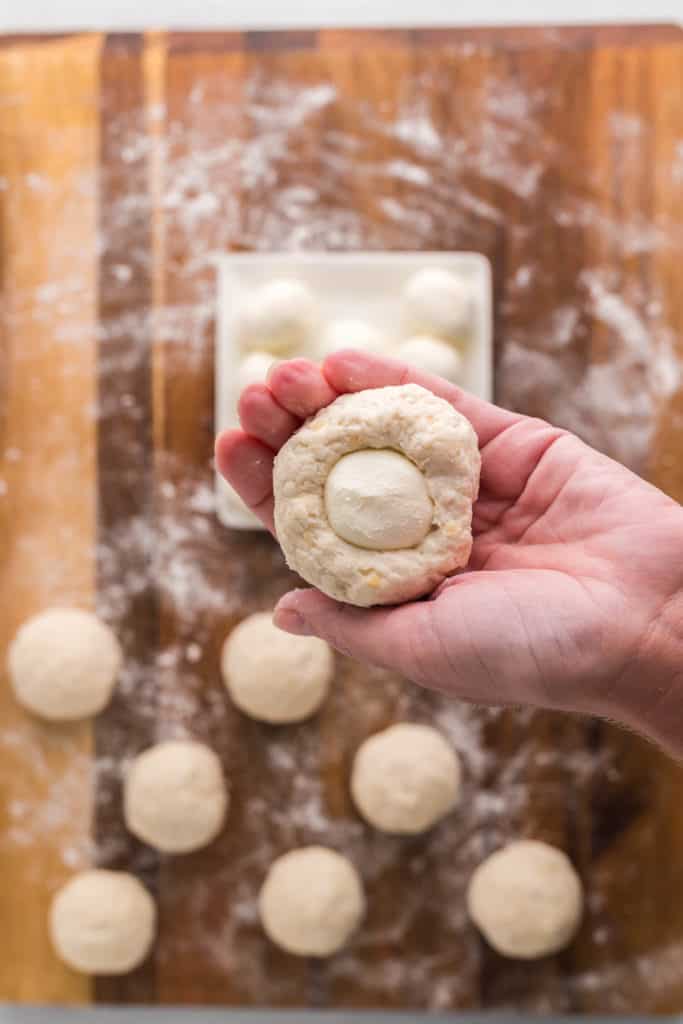 Add the diced cream cheese into the middle of the bagel dough.
