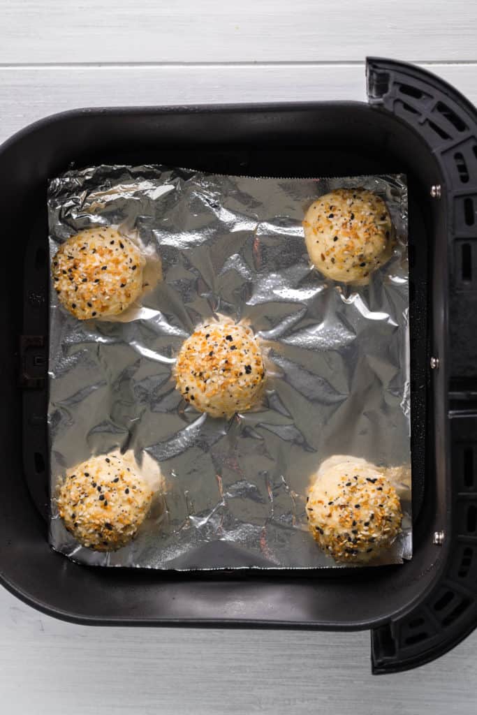 Air frying the mini bagels until they are golden brown and crispy